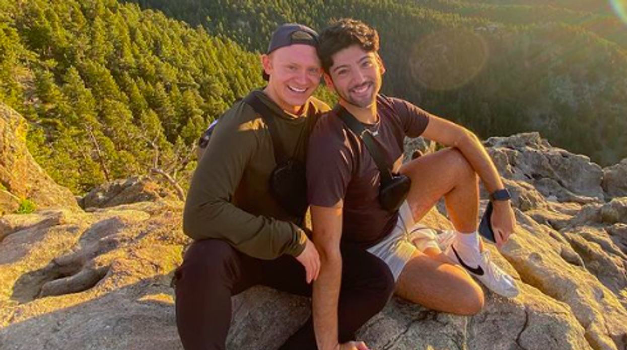 Jose Capetillo and Brendan Ryan sitting on a mountain together.