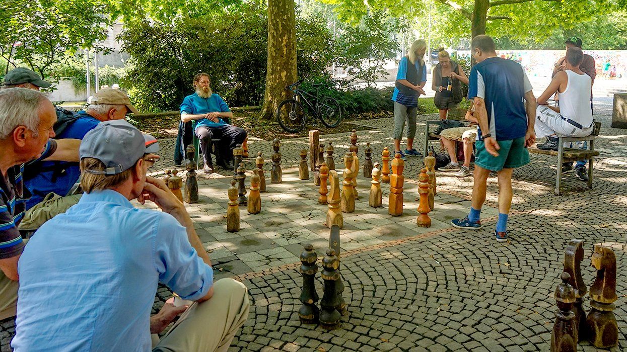 June 2018 Giant Chess board and players at the Hirschgarten Park Munich Upper Bavaria Germany