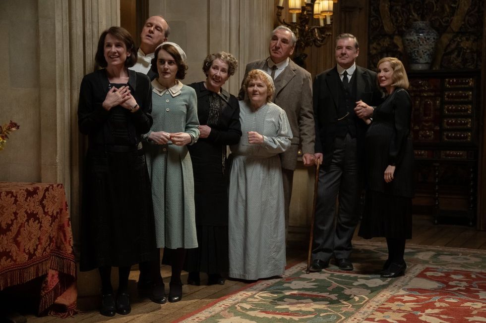 (L to R) Raquel Cassidy stars as Miss Baxter, Kevin Doyle as Mr. Molesley, Sophie McShera as Daisy Parker, Phyllis Logan as Mrs. Hughes, Lesley Nicol as Mrs. Patmore, Jim Carter as Mr. Carson, Brendan Coyle as Mr. Bates and Joanne Froggatt as Anna Bates in DOWNTON ABBEY: The Grand Finale,