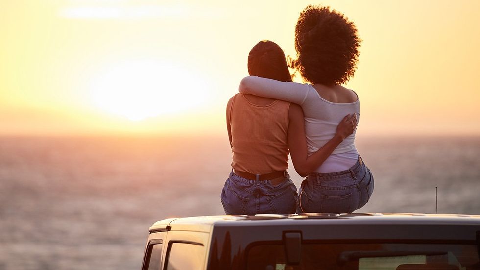 lesbian couple watch a sunset