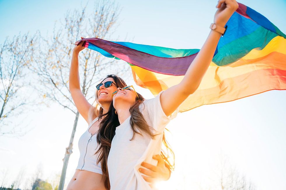 lesbian couple with a pride flag