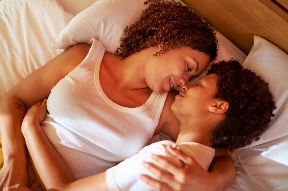 lesbians cuddle in bed