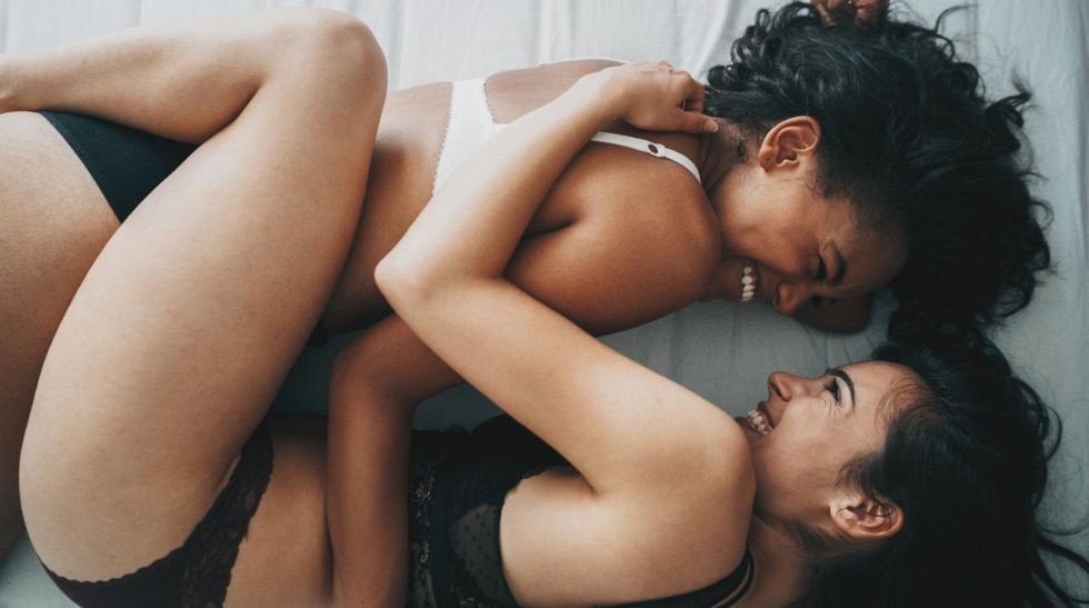 lesbians cuddle in bed