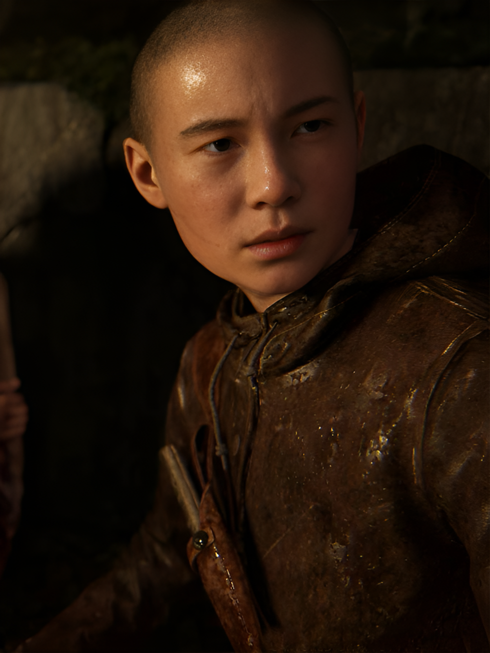 Lev from The Last of Us Part II. He is a 13-year-old Vietnamese-American trans boy with a shaved head. He is wearing a brown leather coat.