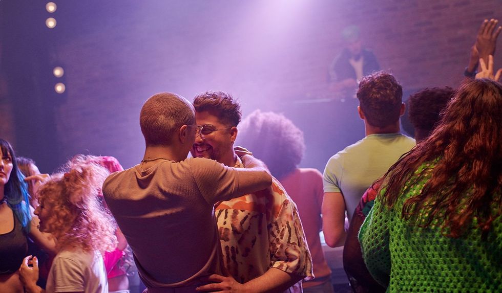 Libra season based on your zodiac sign: gay couple dance at a club