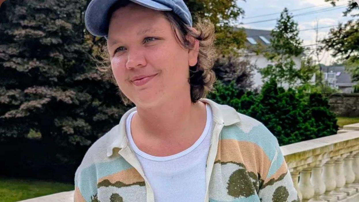 lio cundiff wearing a hat and a colorful sweatshirt