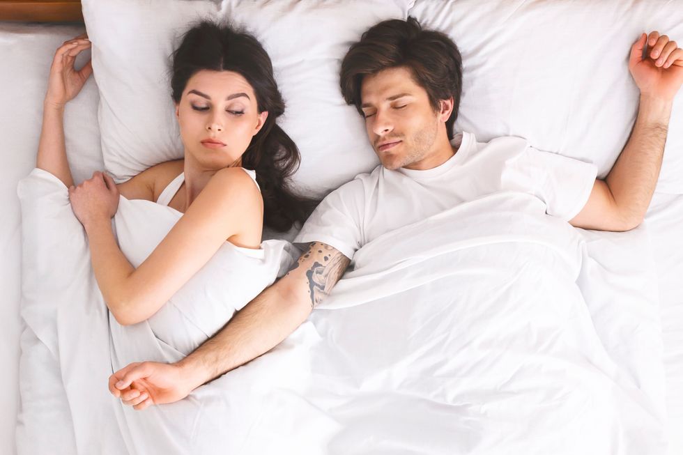 man and woman in bed