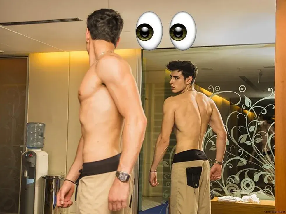man checking himself out in the mirror