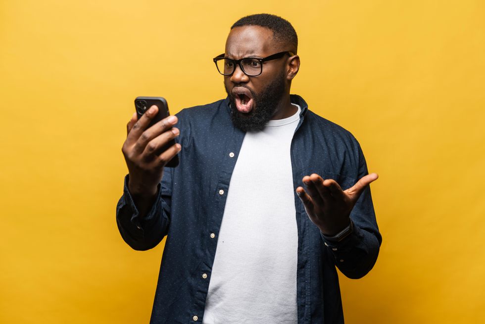 man having a reaction to a text message
