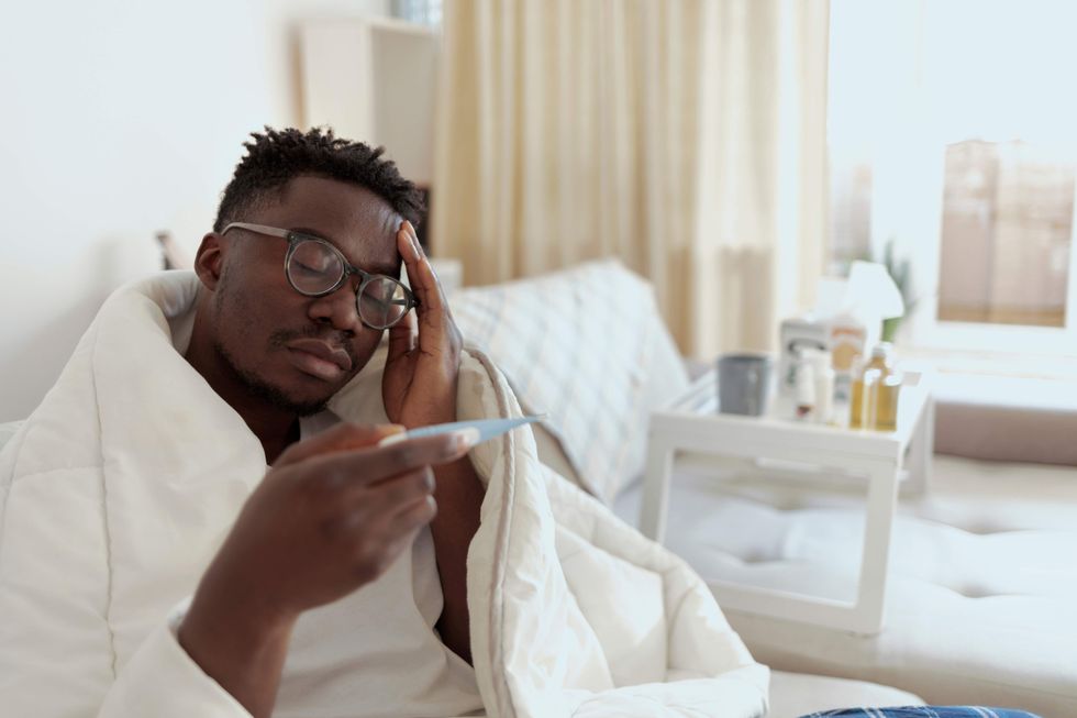Man holding a thermometer