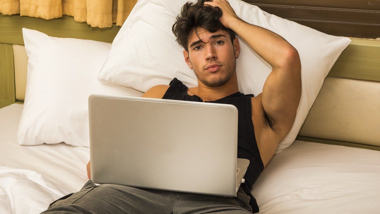 Man in bed with laptop