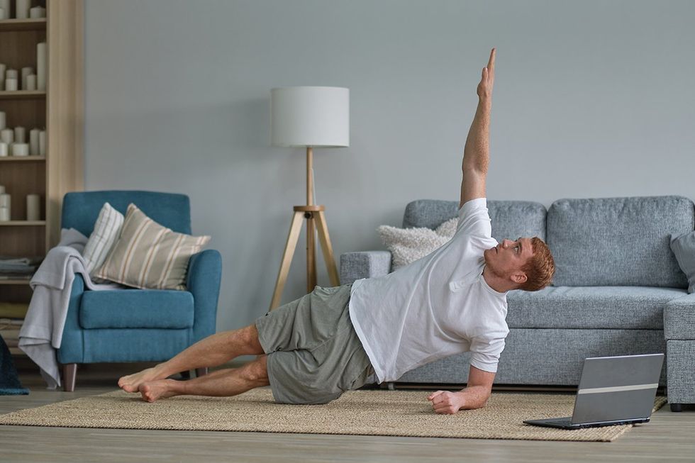 man in forearm side plank