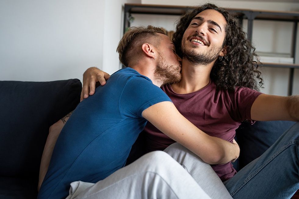 man kissing boyfriend's neck