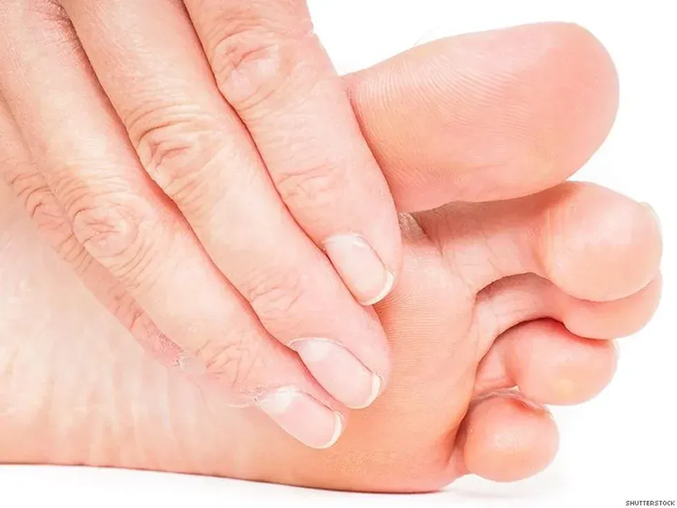 man picking toenail lint