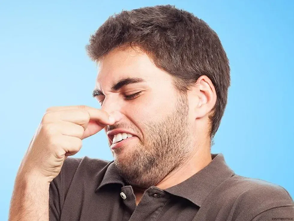 man pinching his nose