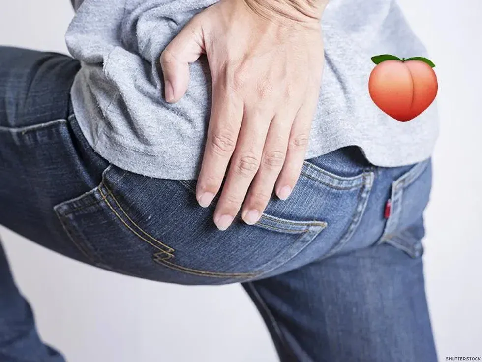 man rubbing his butt