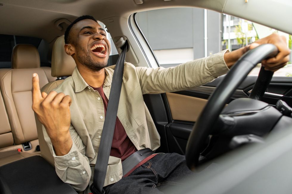man singing in his car