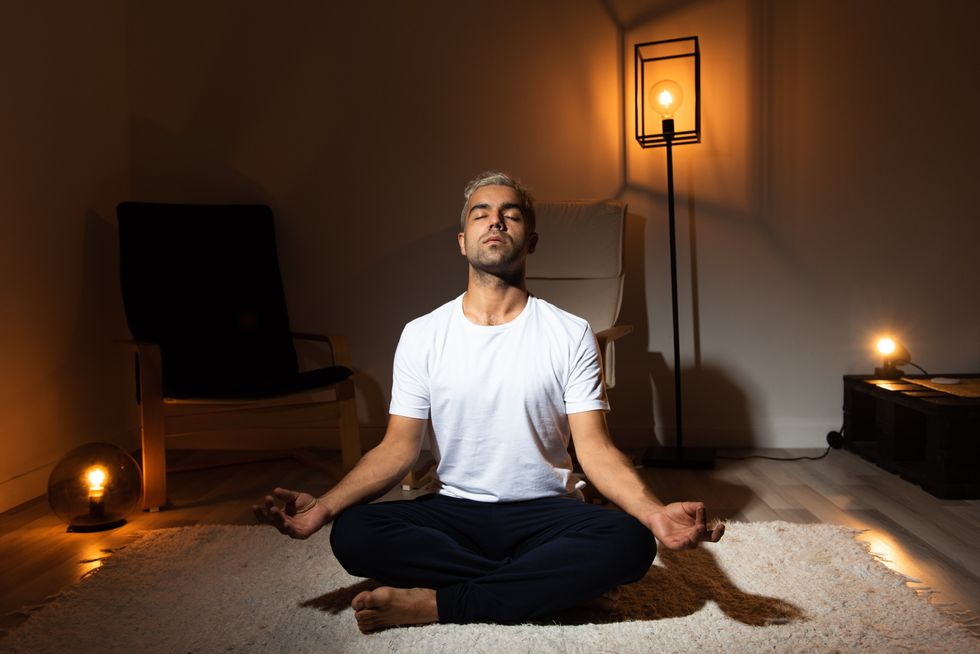 man sitting in meditation