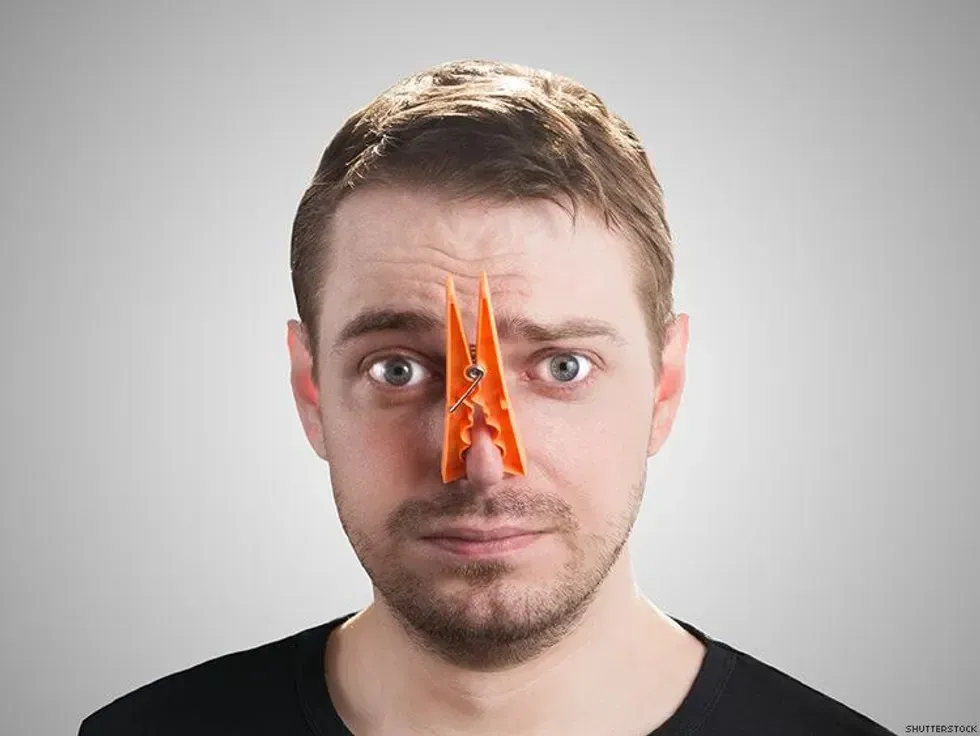 man with a clip on his nose