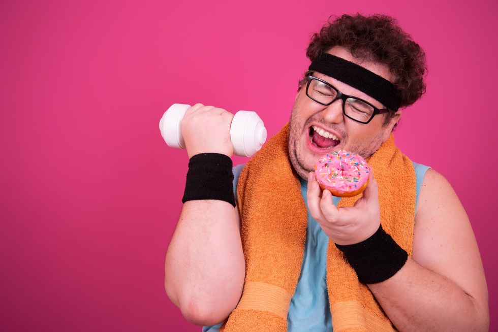man with a donut and a dumbbell