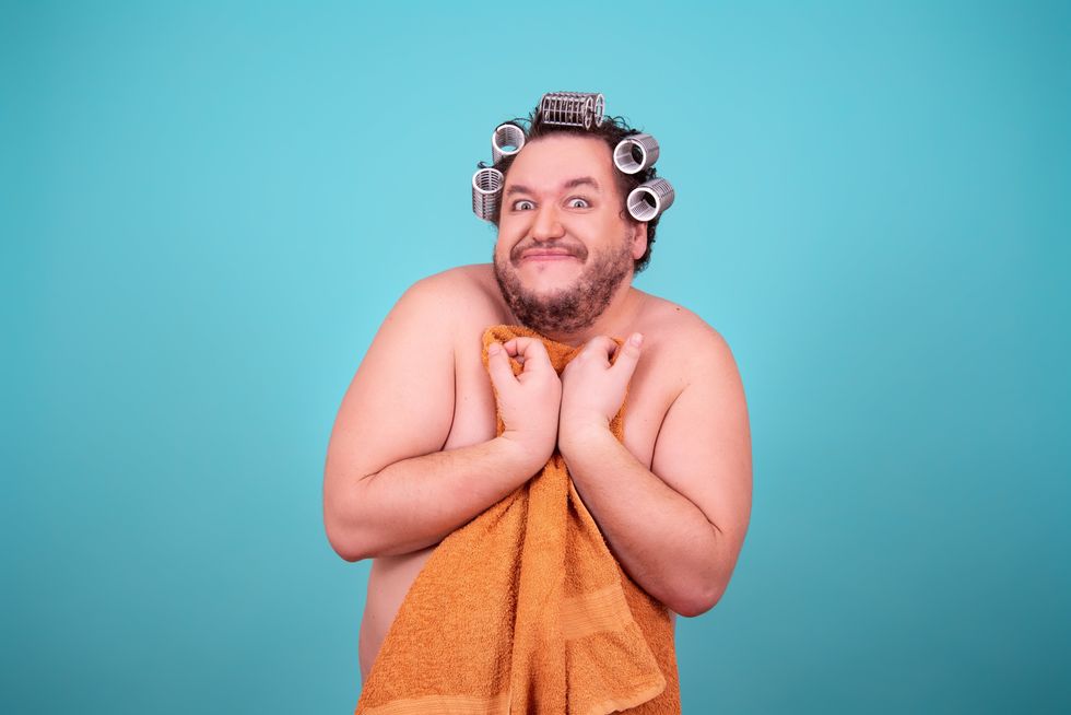 man with hair rollers embarrassed