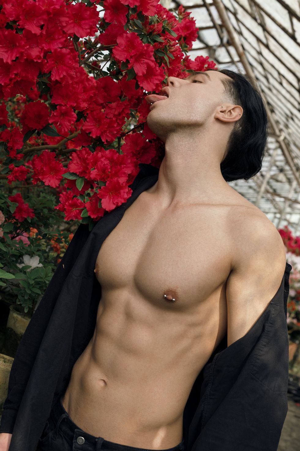 man with nipple ring licking flowers