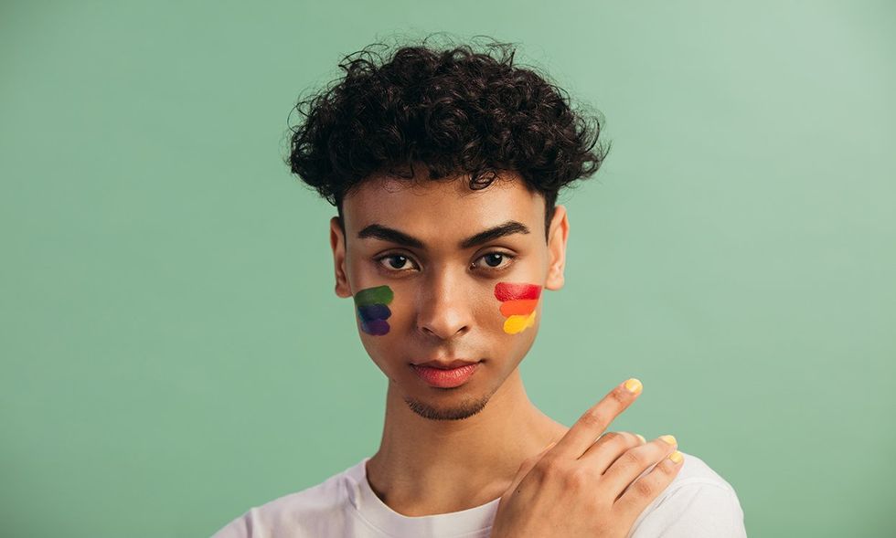 man with pride paint on his face
