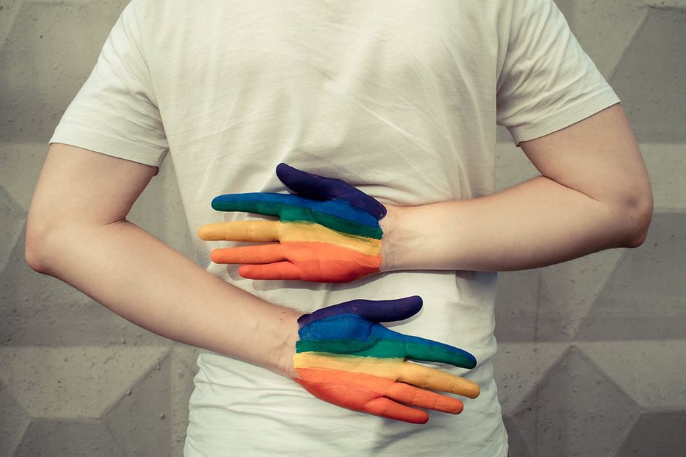 man with rainbow painted hands