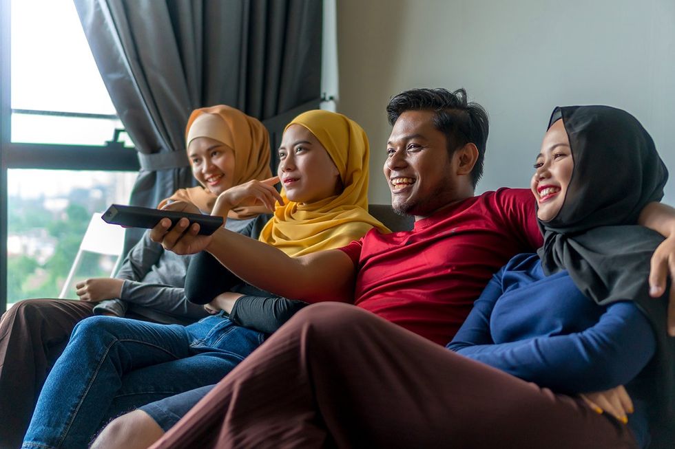 man with three women on a couch