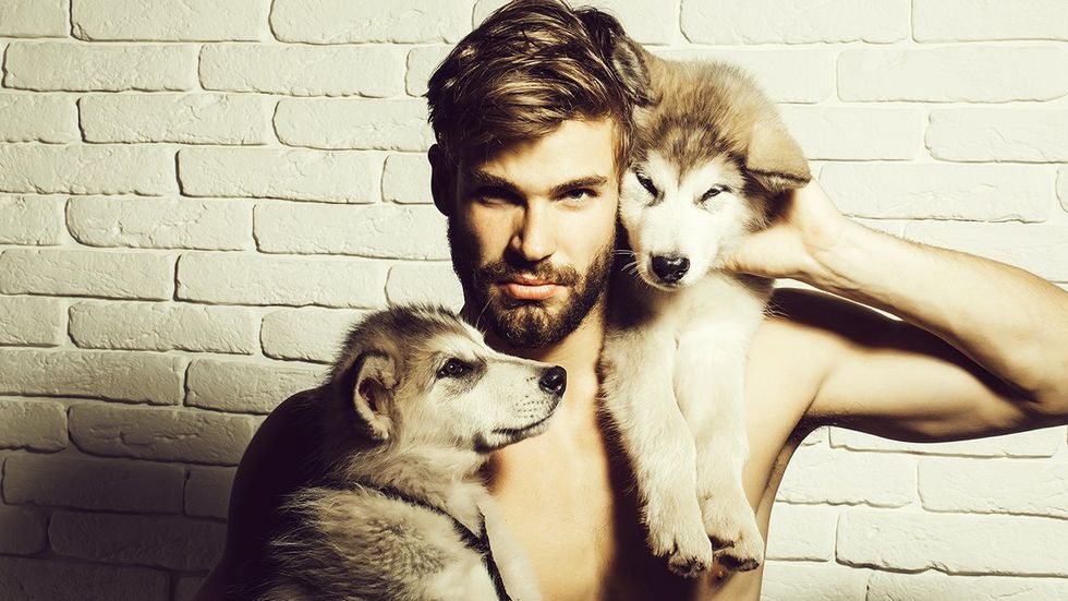 man with wolf puppies