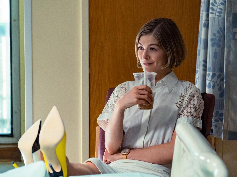 Maria Grayson with her feet up on a desk in I Care a Lot