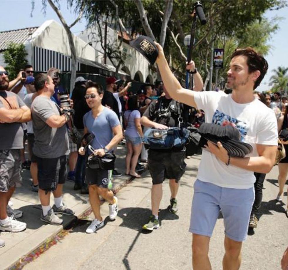 Matt Bomer hands out hats at LA Pride.