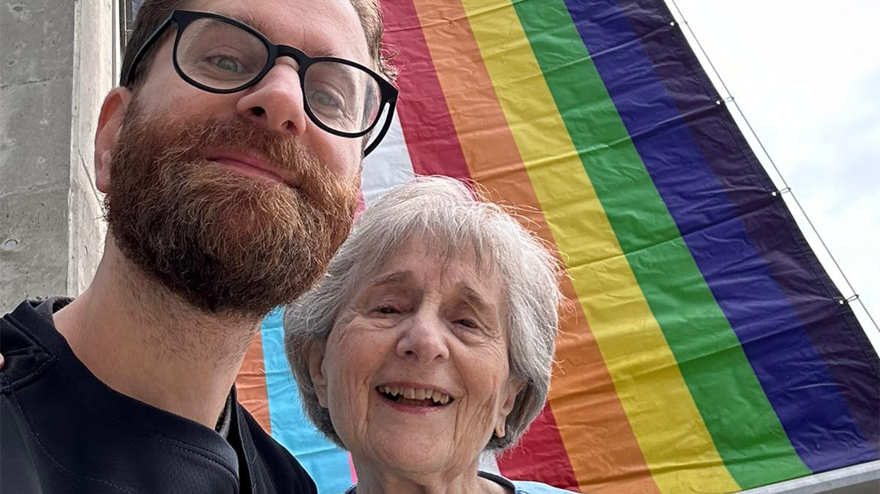 maurie sherman and nana raise pride flag at toronto blue jays stadium