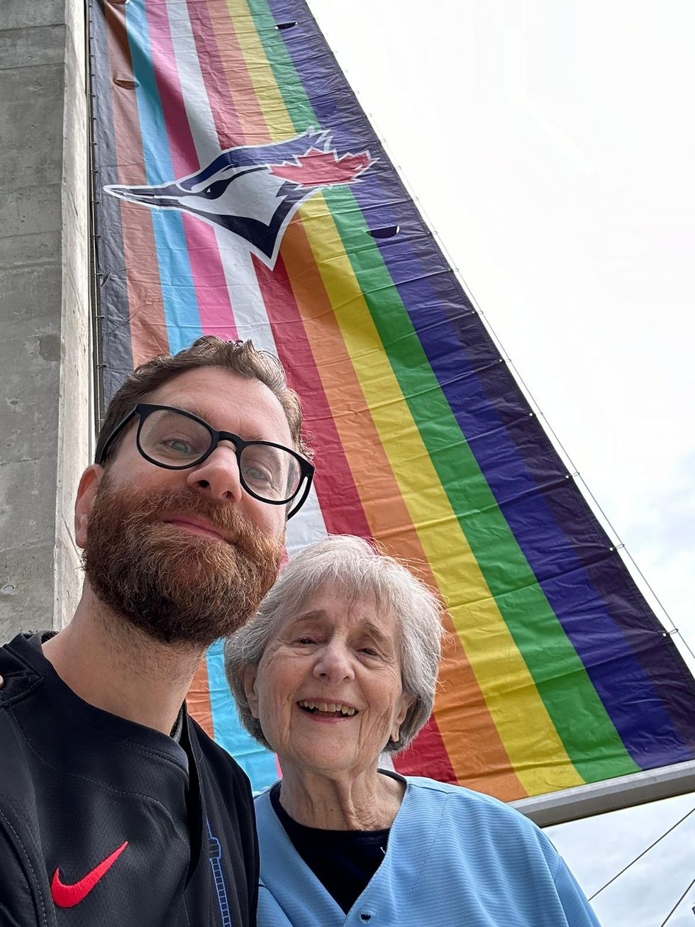 maurie sherman and nana raise pride flag for the blue jays