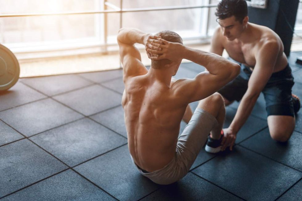 Men doing sit-ups in a gym
