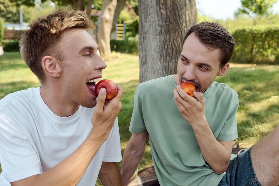 men eating fruit