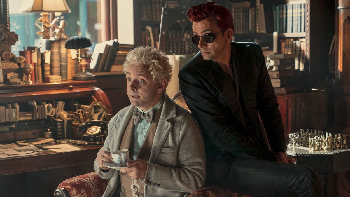 Micheal Sheen (Aziraphale) and David Tennant (Crowley) siting in a chair together in 'Good Omens' season two