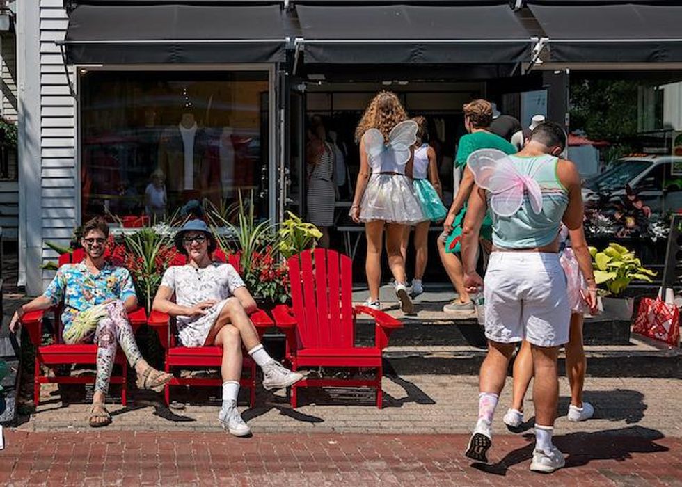Mix of glam and relaxed queer people enjoying the relaxing and exciting shops and leisure spots in Provincetown