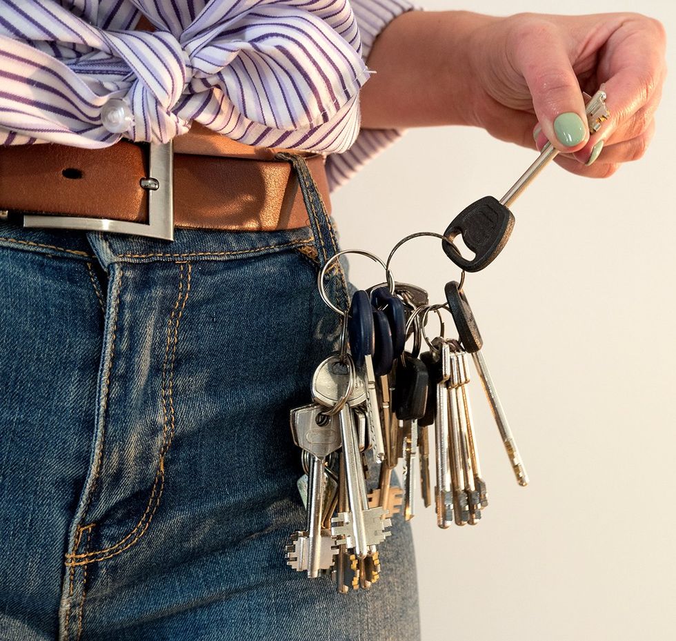 multiple keys hanging from jeans belt loop she is holding one up with green nail polish manicure photo gallery listicle Lesbians reveal the spiciest things on their sexual bucket list