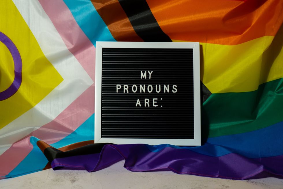 MY PRONOUNS ARE text Neo pronouns concept on Rainbow flag background gender pronouns. Non-binary people rights transgenders. Lgbtq community support assume my gender tolerance equal rights
