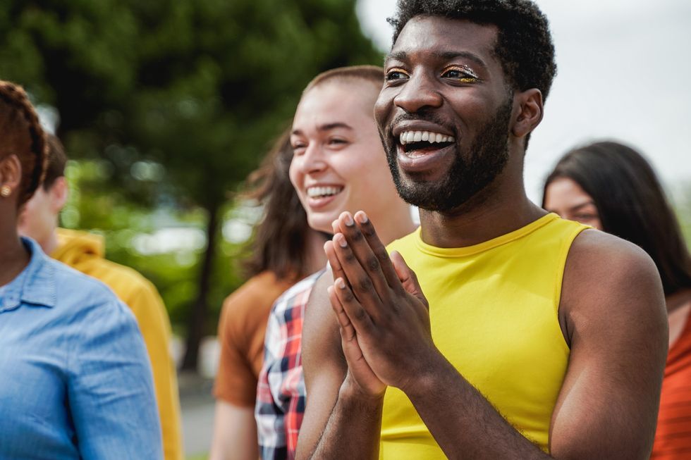 nonbinary person clapping