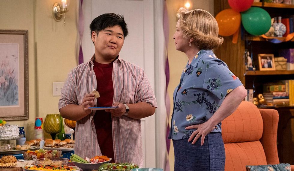 ozzie and kitty talk by a table of food