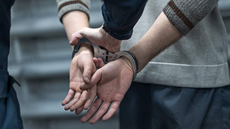 person being handcuffed by police officer