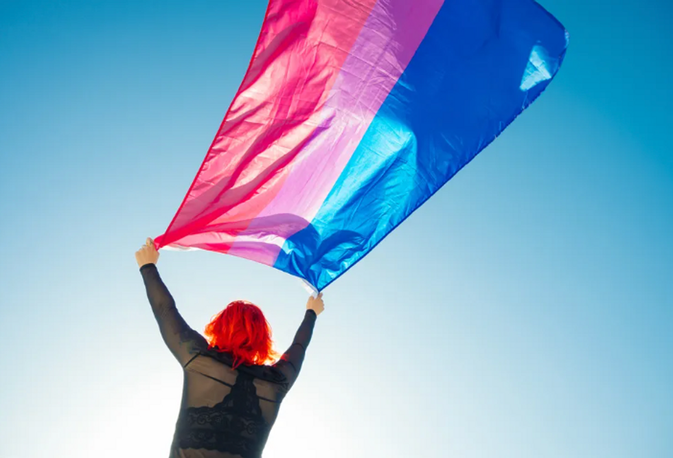 person carrying the bisexual flag