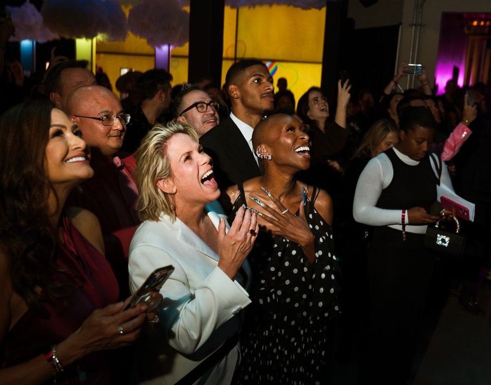 photo gallery queer photographer Roland Fitz Out100 2024 party pics crowd laughing cheering focus on Tracy E Gilchrist Cynthia Erivo