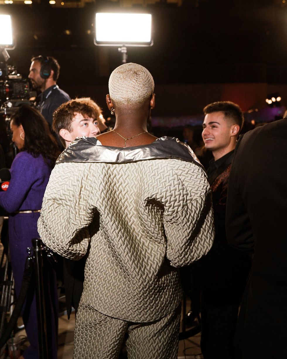 photo gallery queer photographer Roland Fitz Out100 2024 party pics vinvicint from behind speaking to Kevin McHale and Ricky Cornish