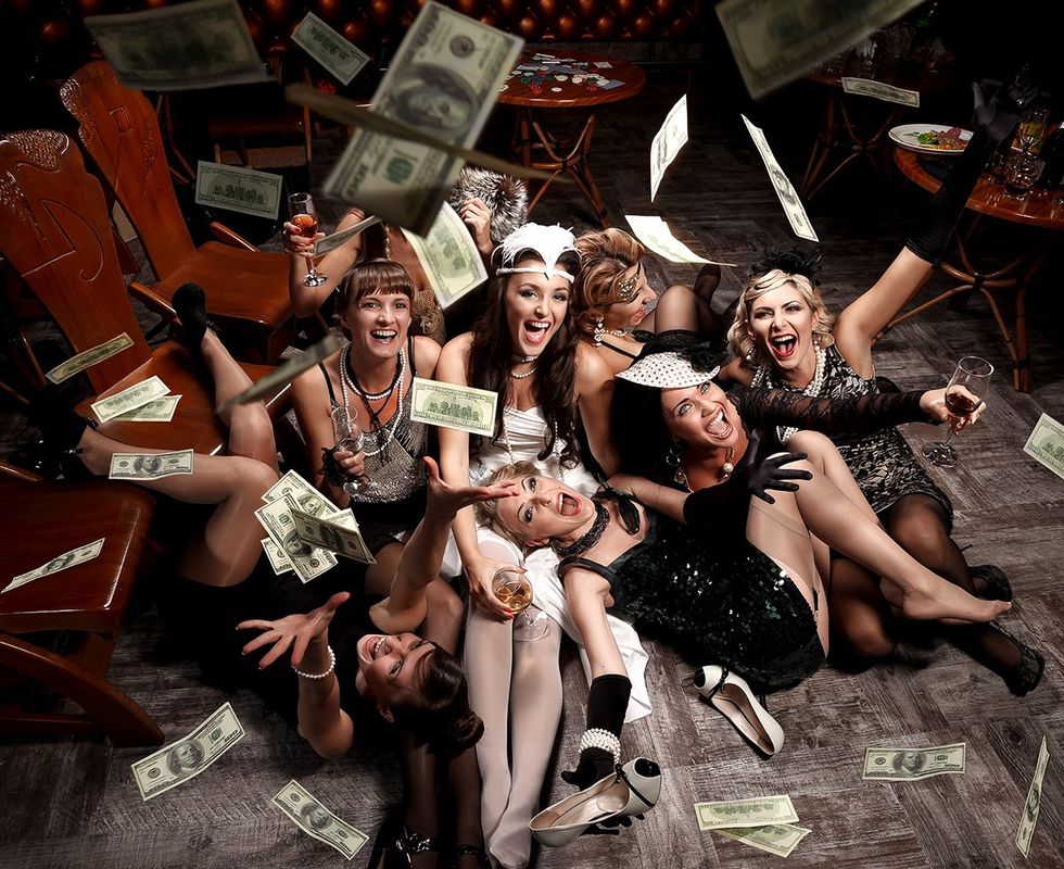 poker night party laughing happy women in vintage outfits with drinks money raining down photo gallery listicle Lesbians reveal the spiciest things on their sexual bucket list