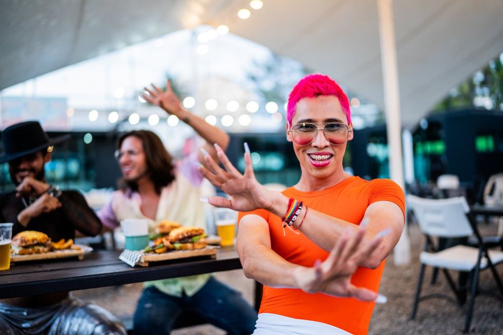 Portrait of mid adult man with friends at a food truck festival -