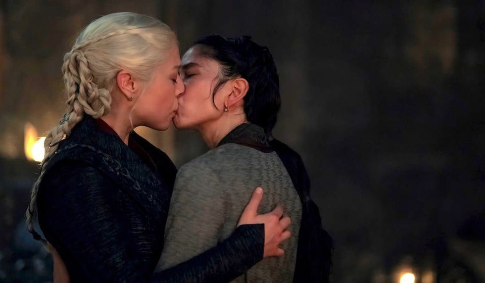 Queen Rhaenyra Targaryen and her spymaster Mysaria share a kiss
