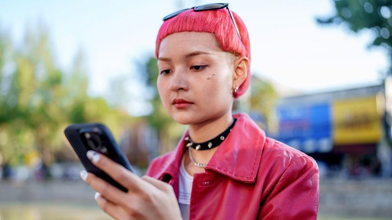 queer teen using cellphone